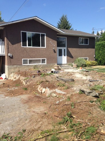 The 1974 split entry, 3 bedroom poorly maintained but 1/2 acre of flat land that is ours.